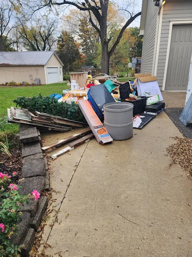 Dumpster being loaded with debris for 10 Yard Dumpster Rental in Tulsa